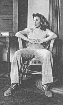 Isabel Bloom sitting in a chair with hands folded and fingers intertwined