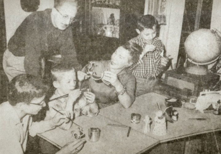 Isabel Bloom in her home with John and their children