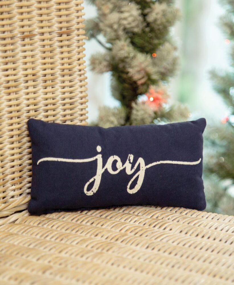 This cute and cozy mini pillow features a festive navy color and reads, “joy” in white script on the front Pillow Mini -Blue Joy