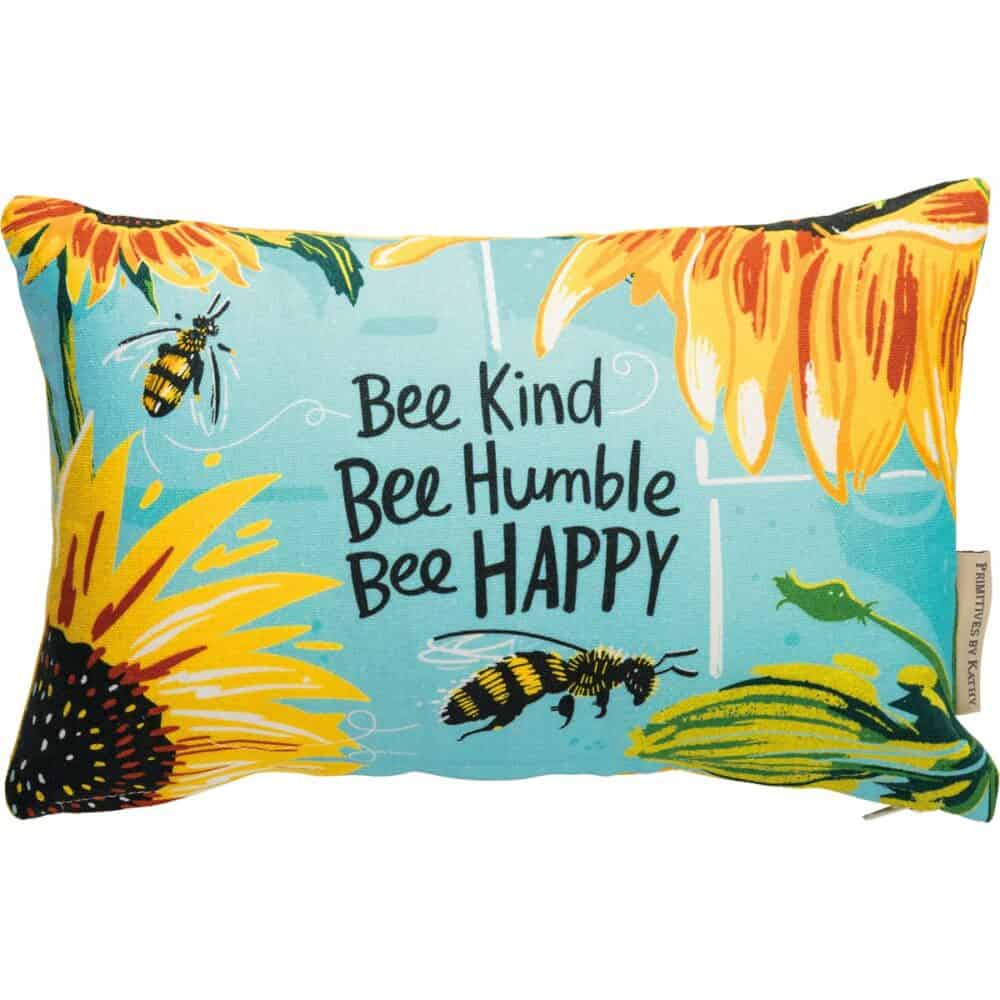 A double sided cotton pillow featuring a hand lettered Bee Kind Bee Humble Bee Happy sentiment with bee and sunflower designs on the front and coordinating bee and honeycomb designs on the back Pillow Bee Kind
