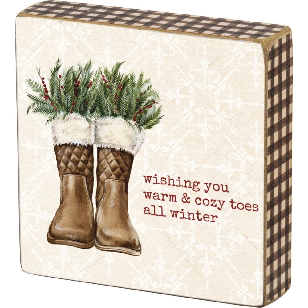 A wooden block box sign featuring a "Wishing You Warm and Cozy Toes All Winter" sentiment. This accessory is part of our IB Home Accents line and was carefully selected to complement our unique sculptures.