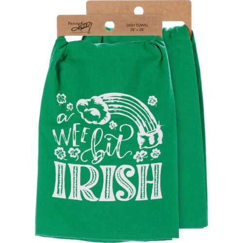 A cotton kitchen towel for St. Patrick's Day featuring chalk art "A Wee Bit Irish" sentiment with shamrock and rainbow pot of gold designs. This accessory is part of our IB Home Accents line and was carefully selected to complement our unique sculptures.