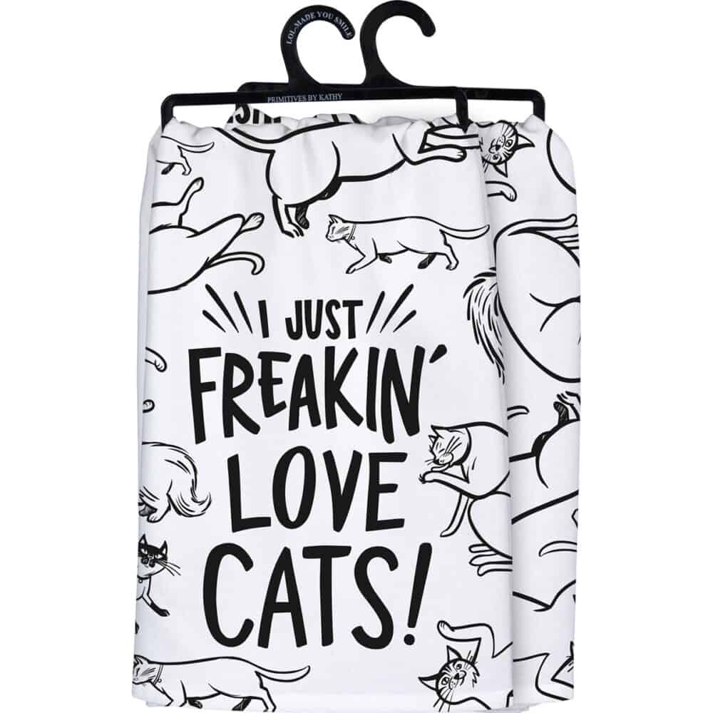 A black and white cotton kitchen towel featuring I Just Freakin Love Cats sentiment and all over cat designs.